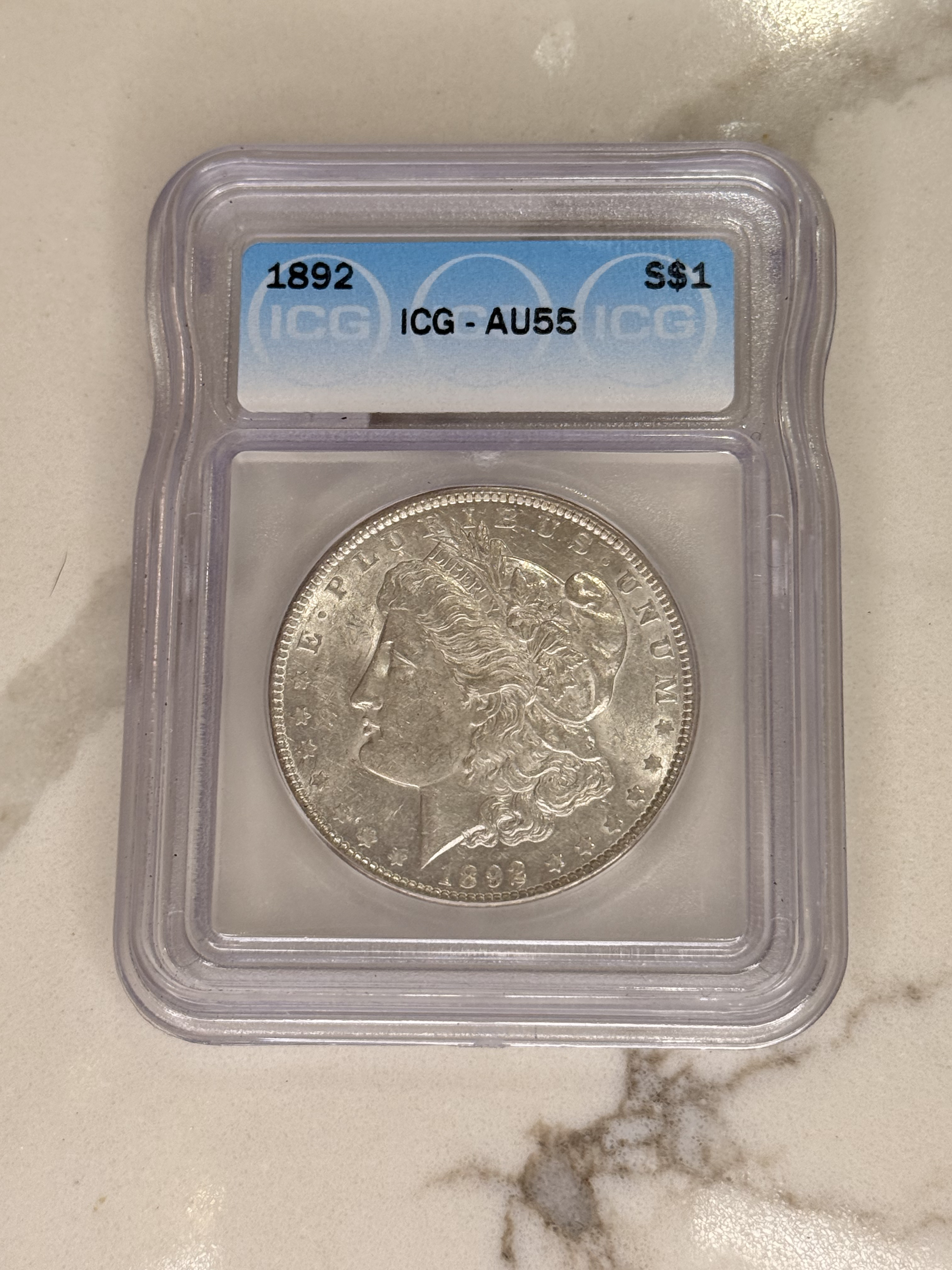 Actual coin and holder — front