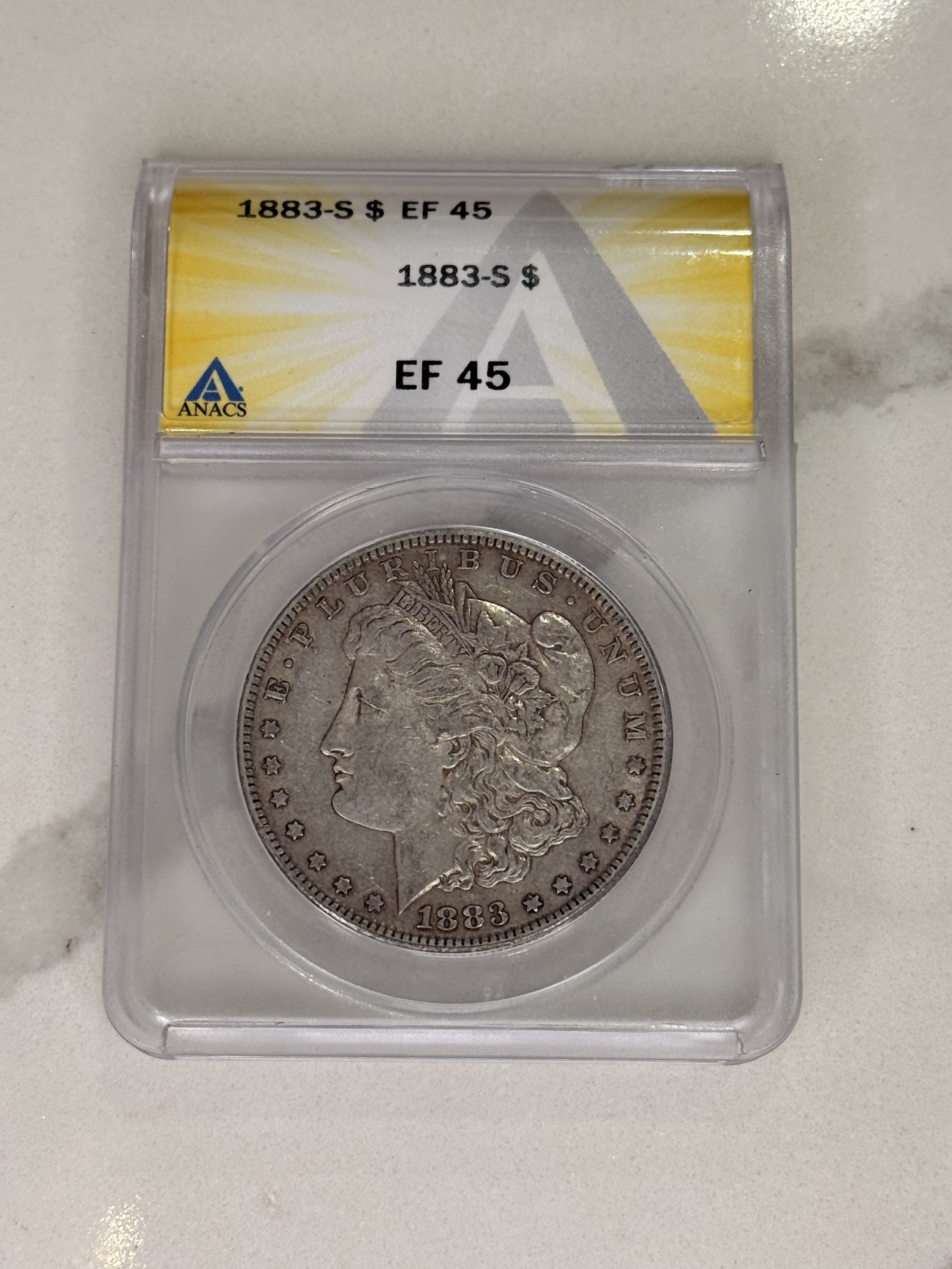 Actual coin and holder — front