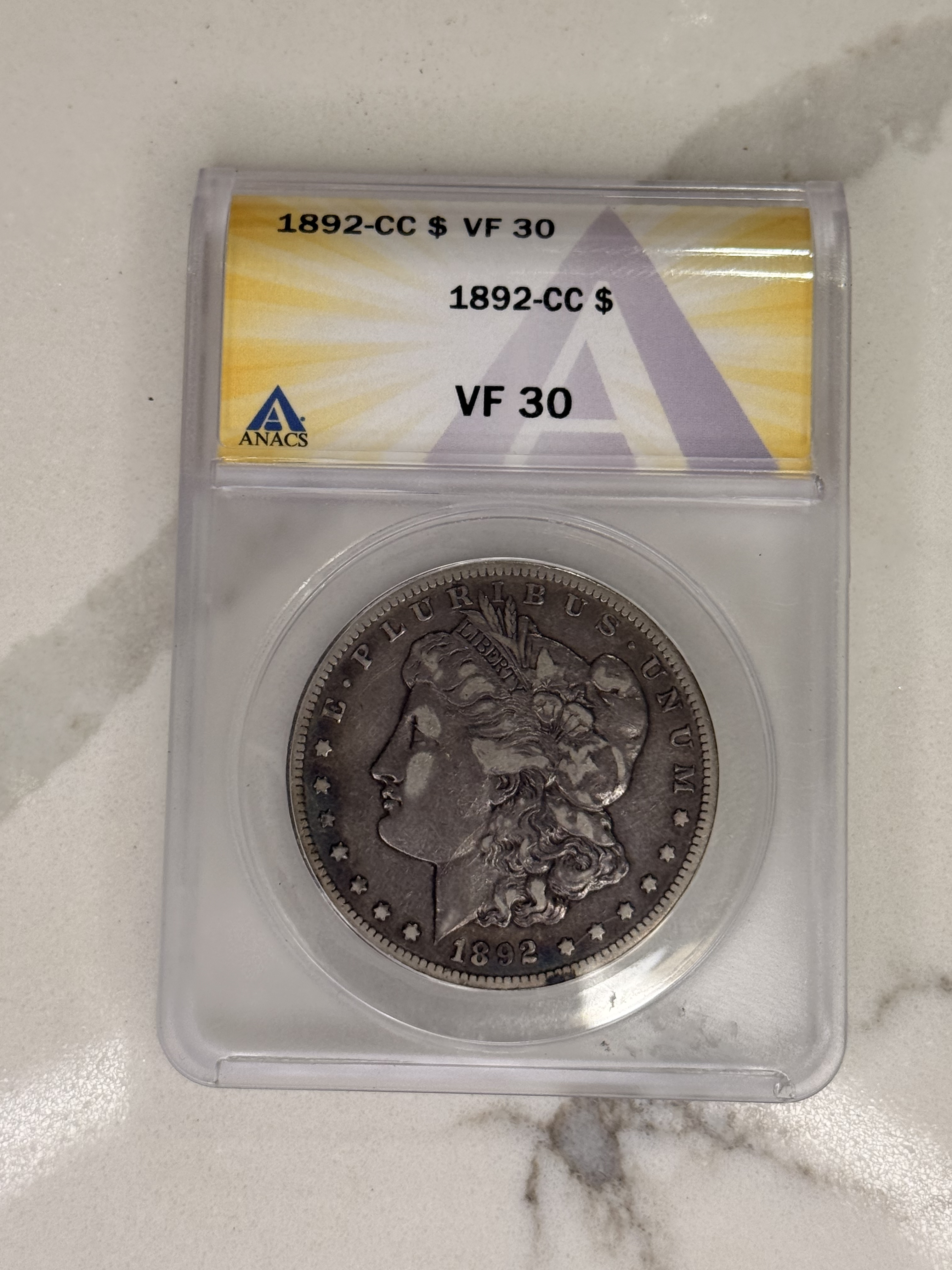 Actual coin and holder — front