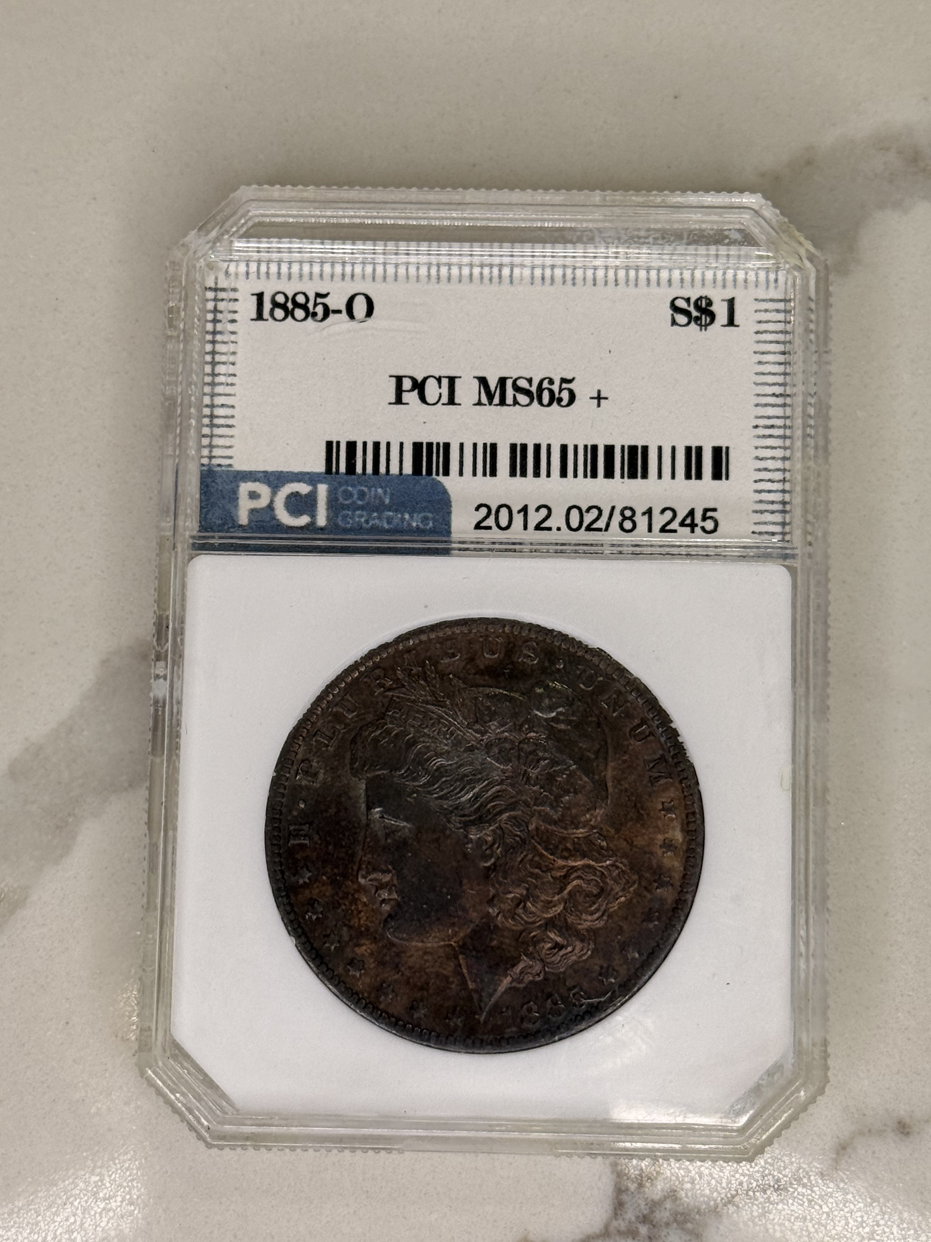 Actual coin and holder — front