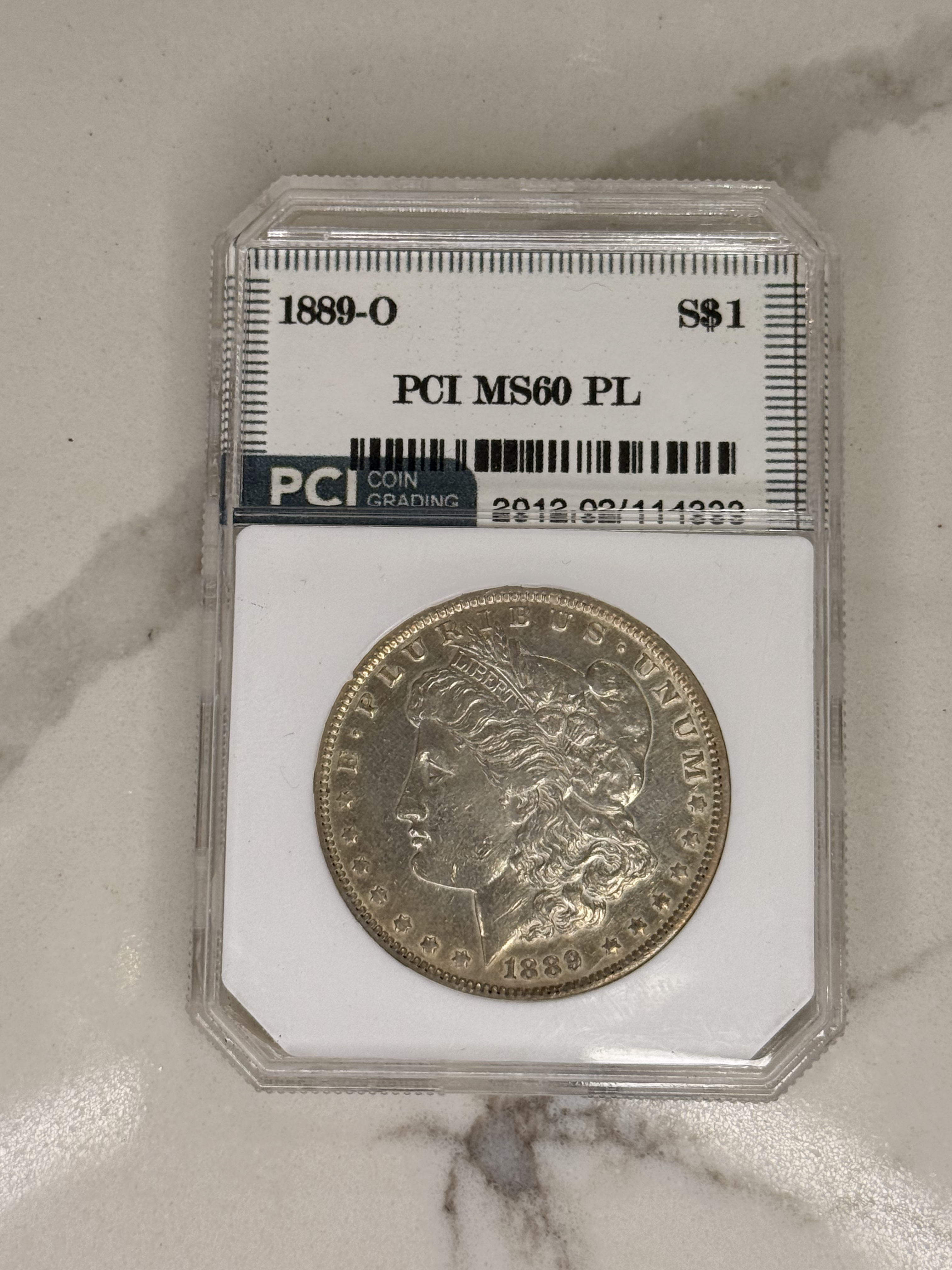 Actual coin and holder — front