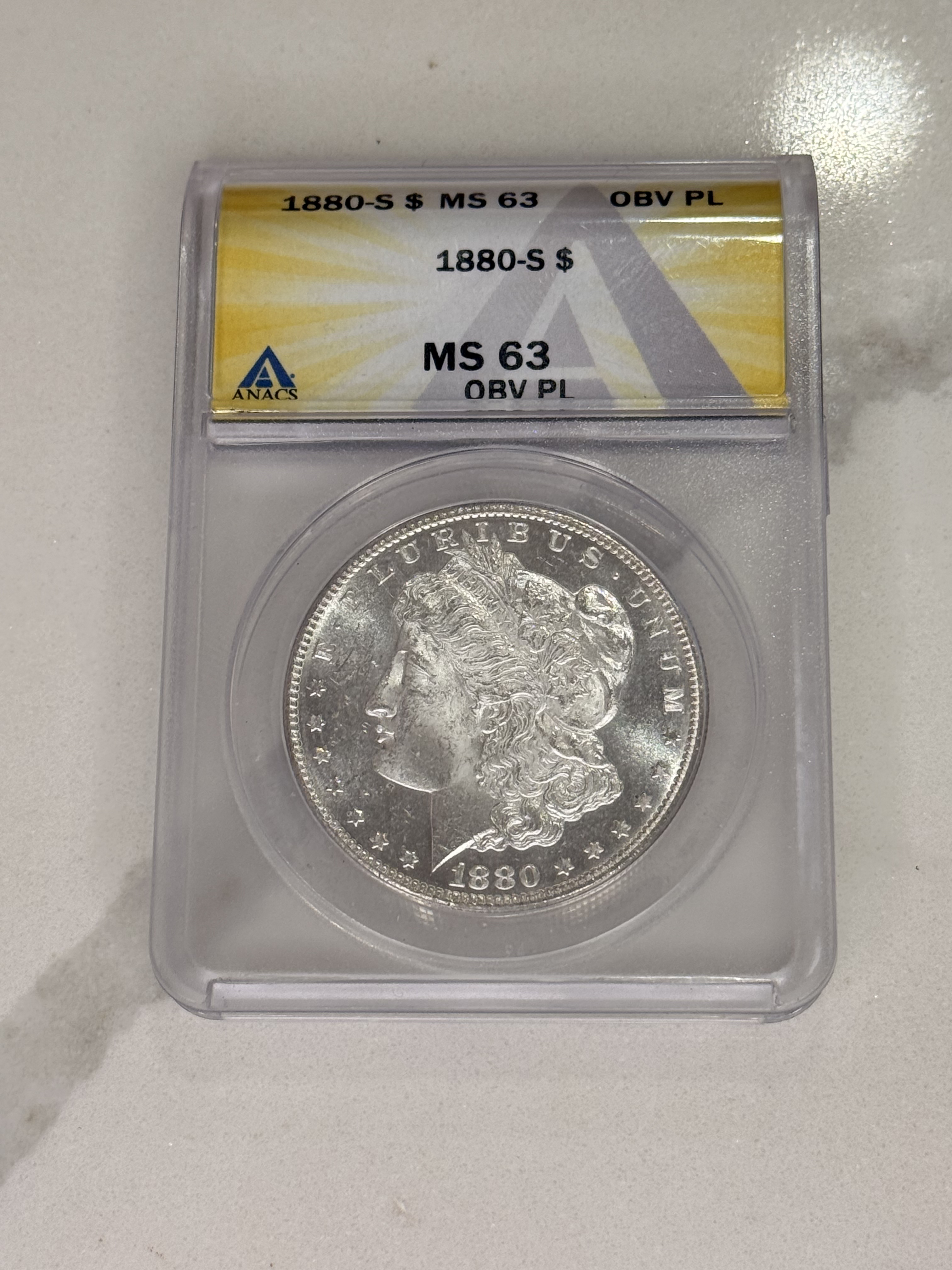 Actual coin and holder — front