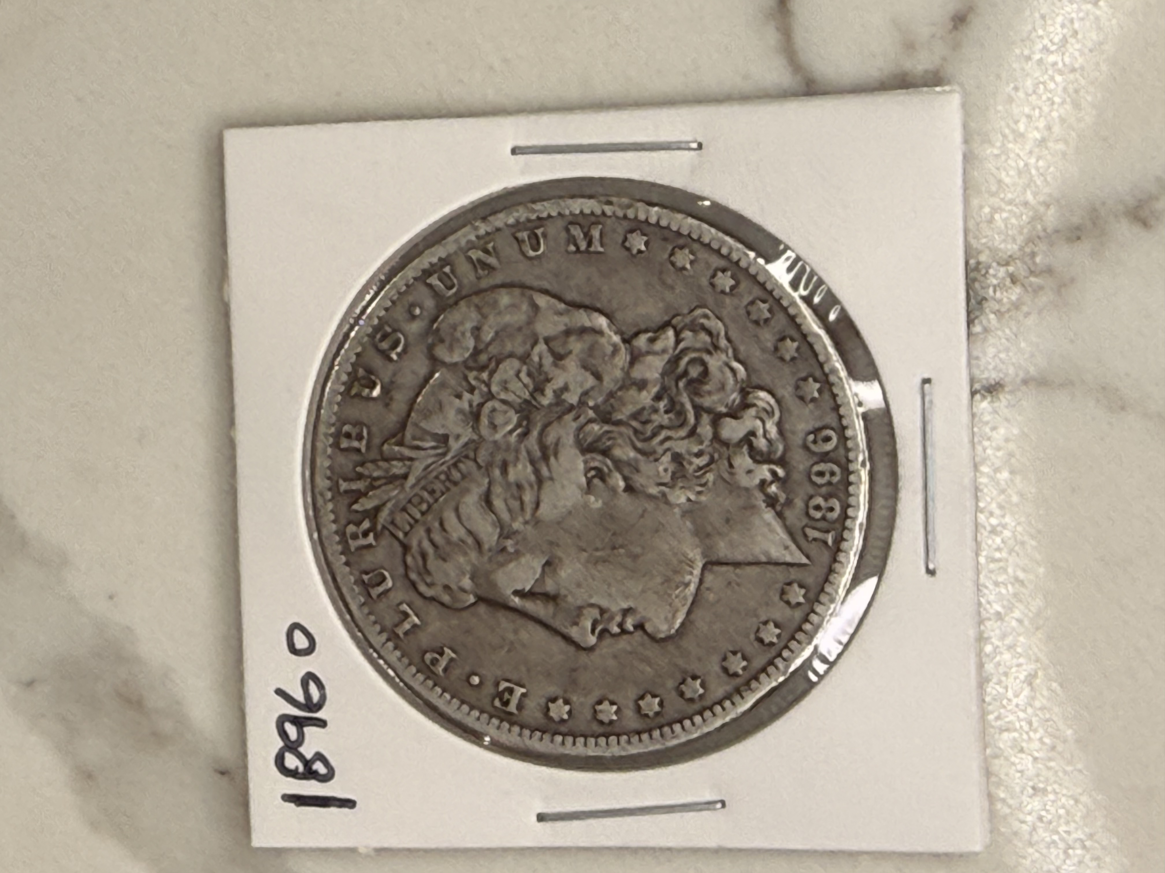 Actual coin and holder — front