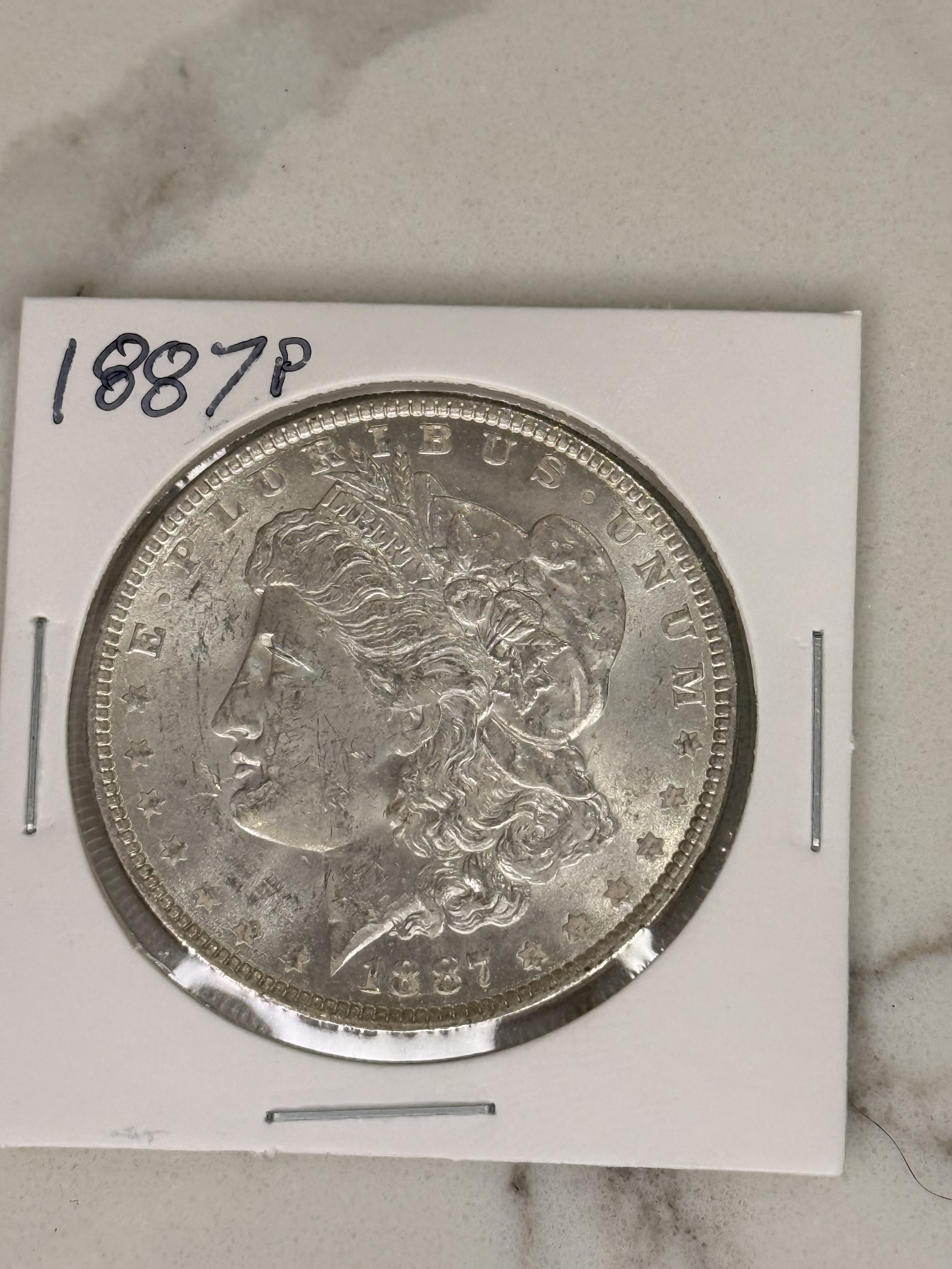 Actual coin and holder — front