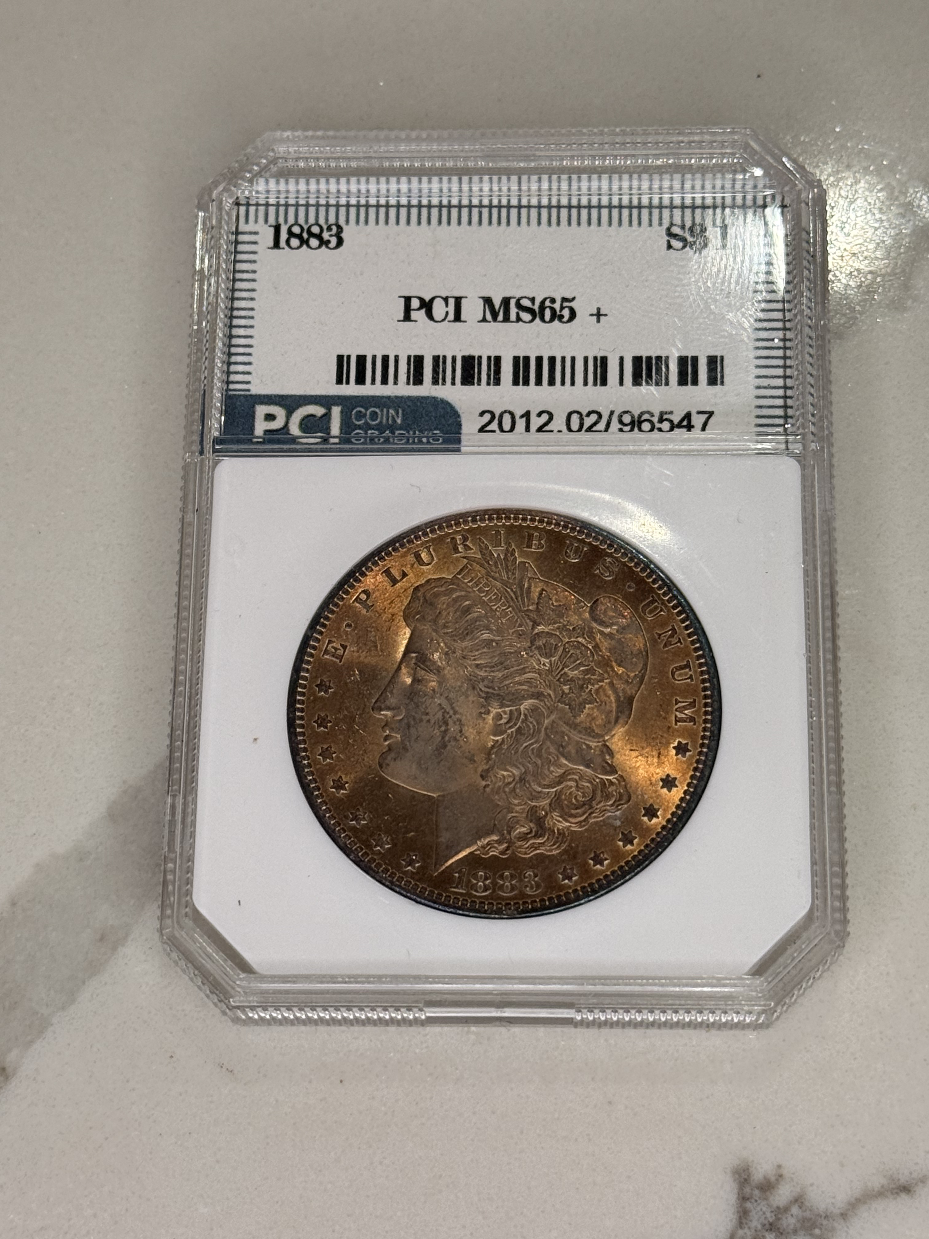 Actual coin and holder — front