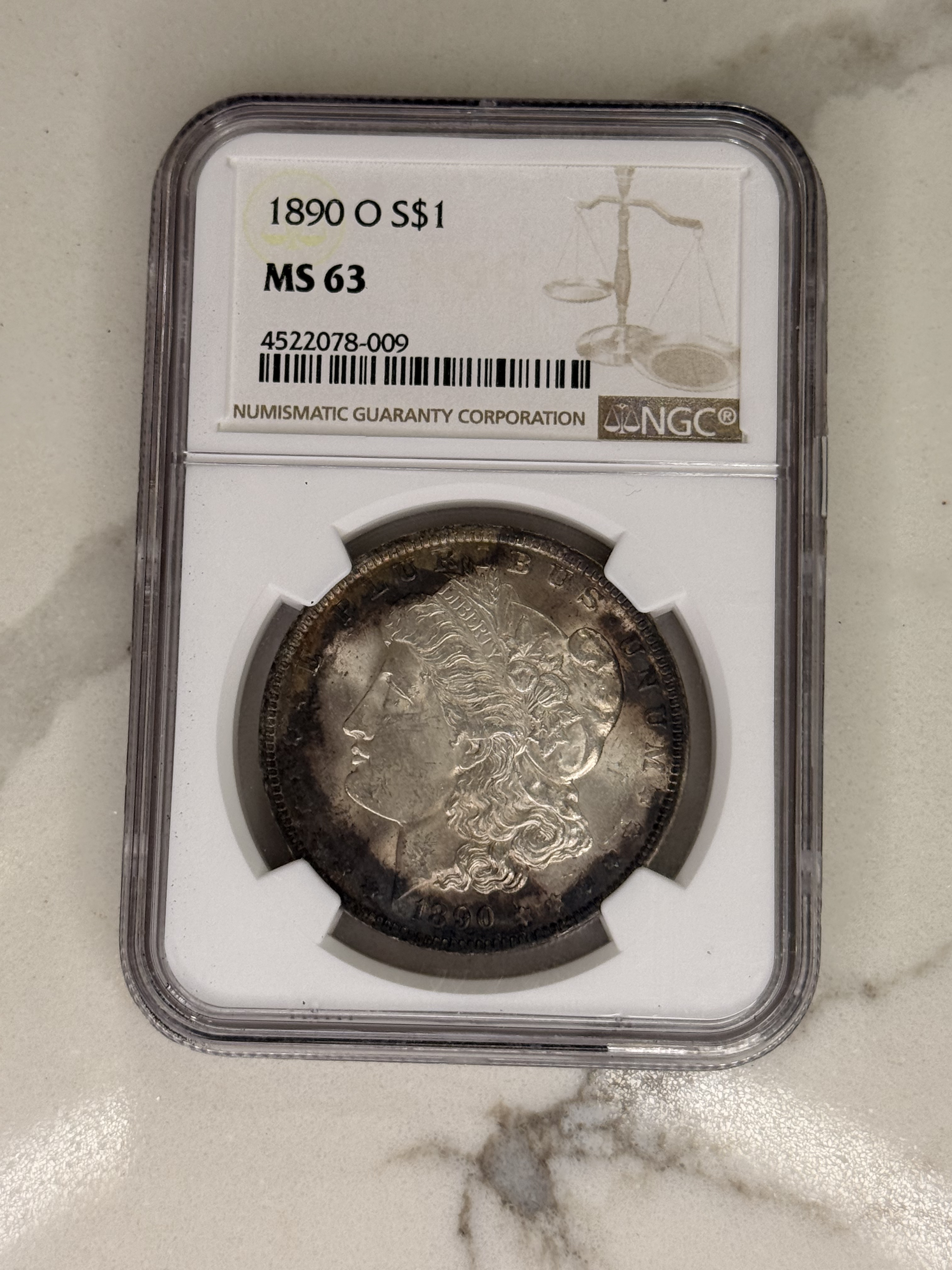 Actual coin and holder — front