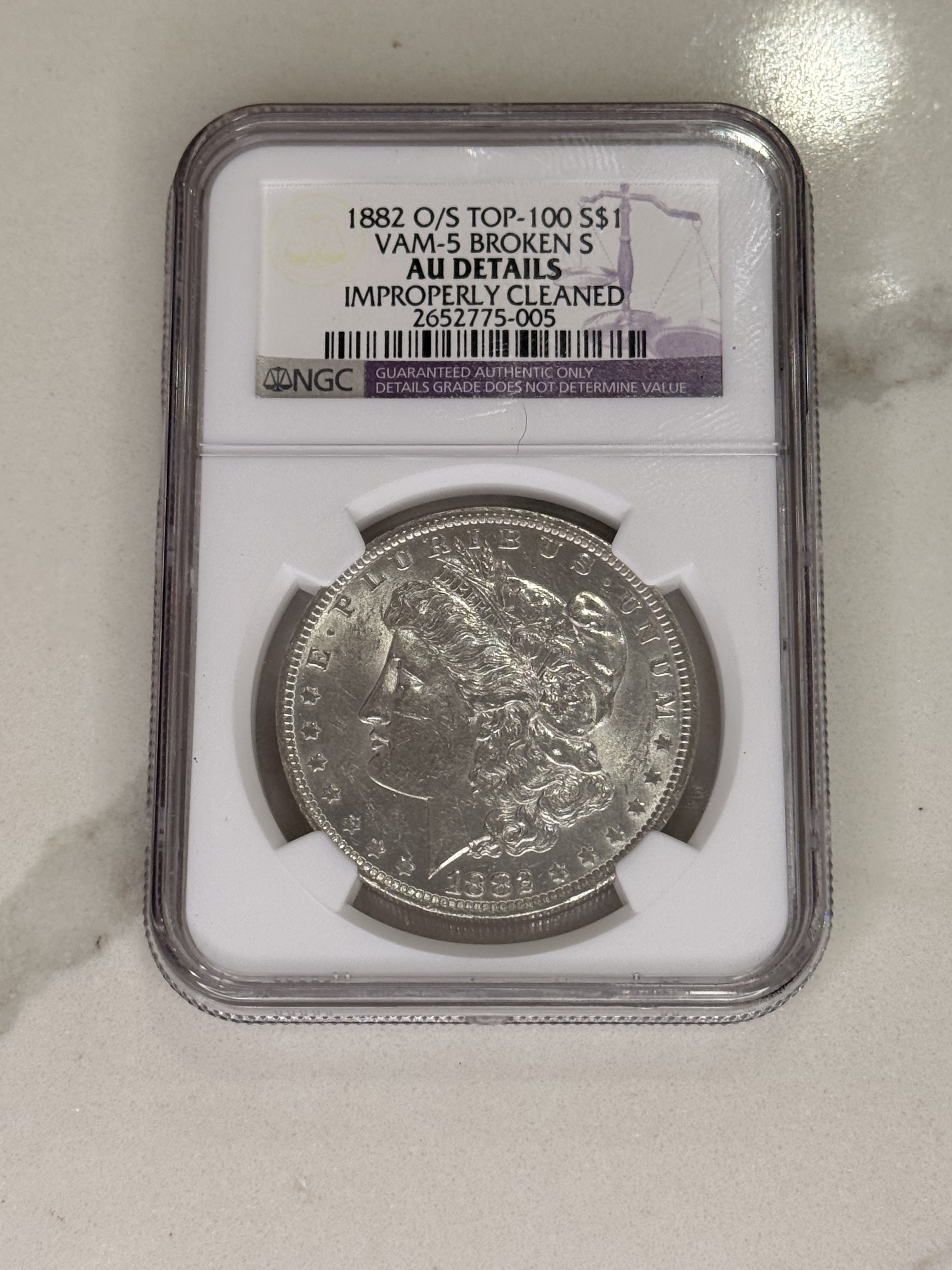Actual coin and holder — front