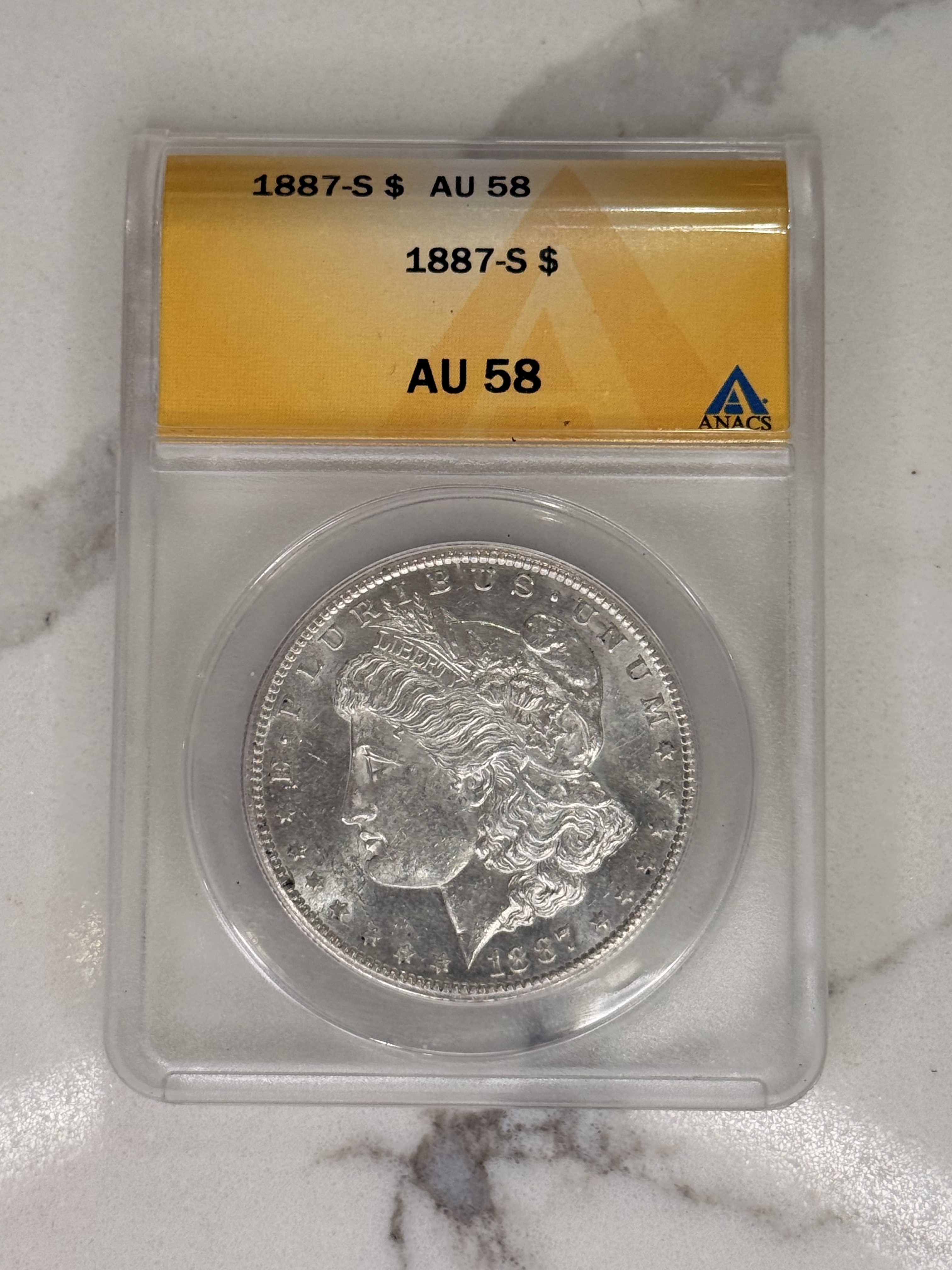 Actual coin and holder — front