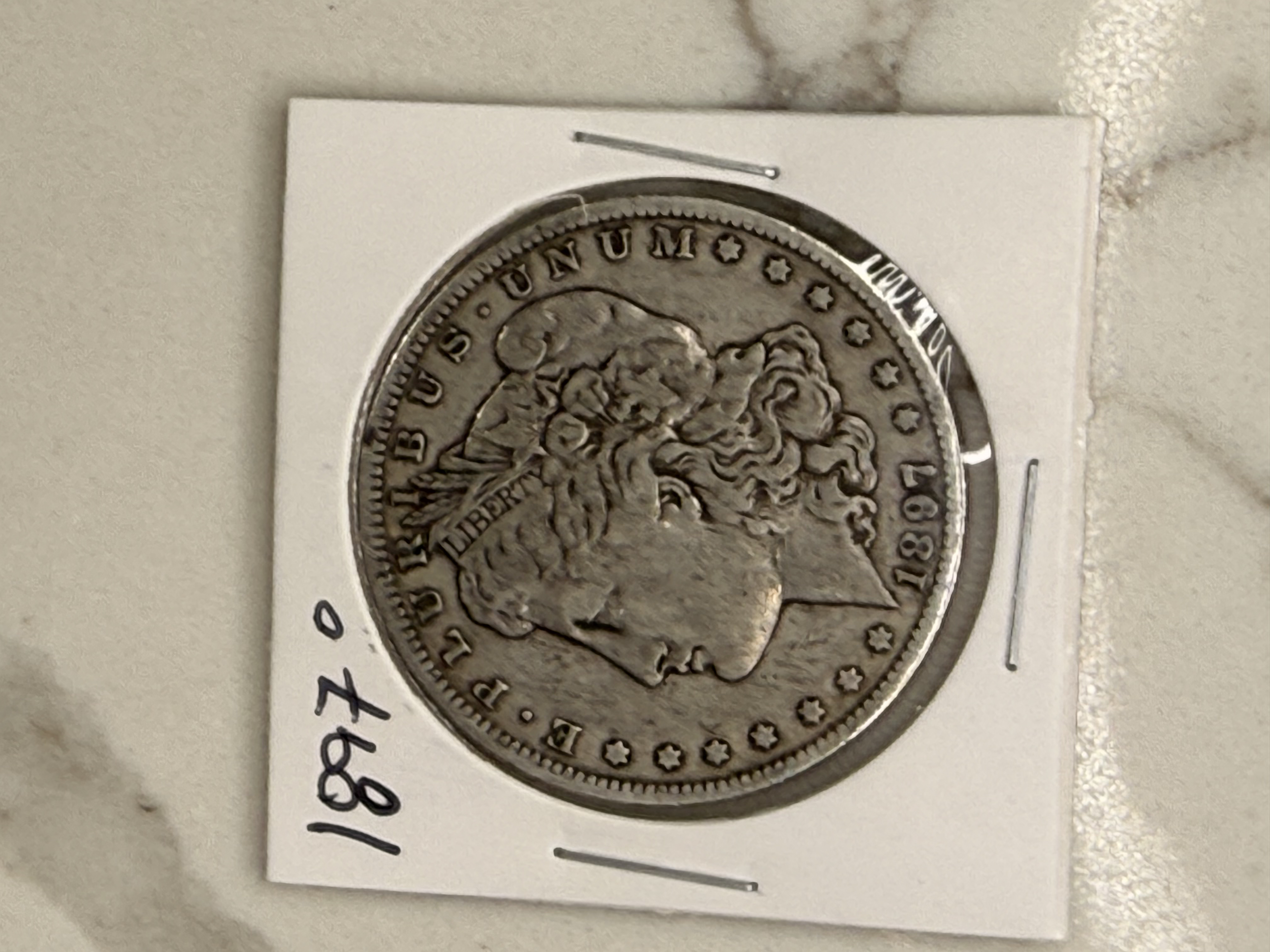 Actual coin and holder — front
