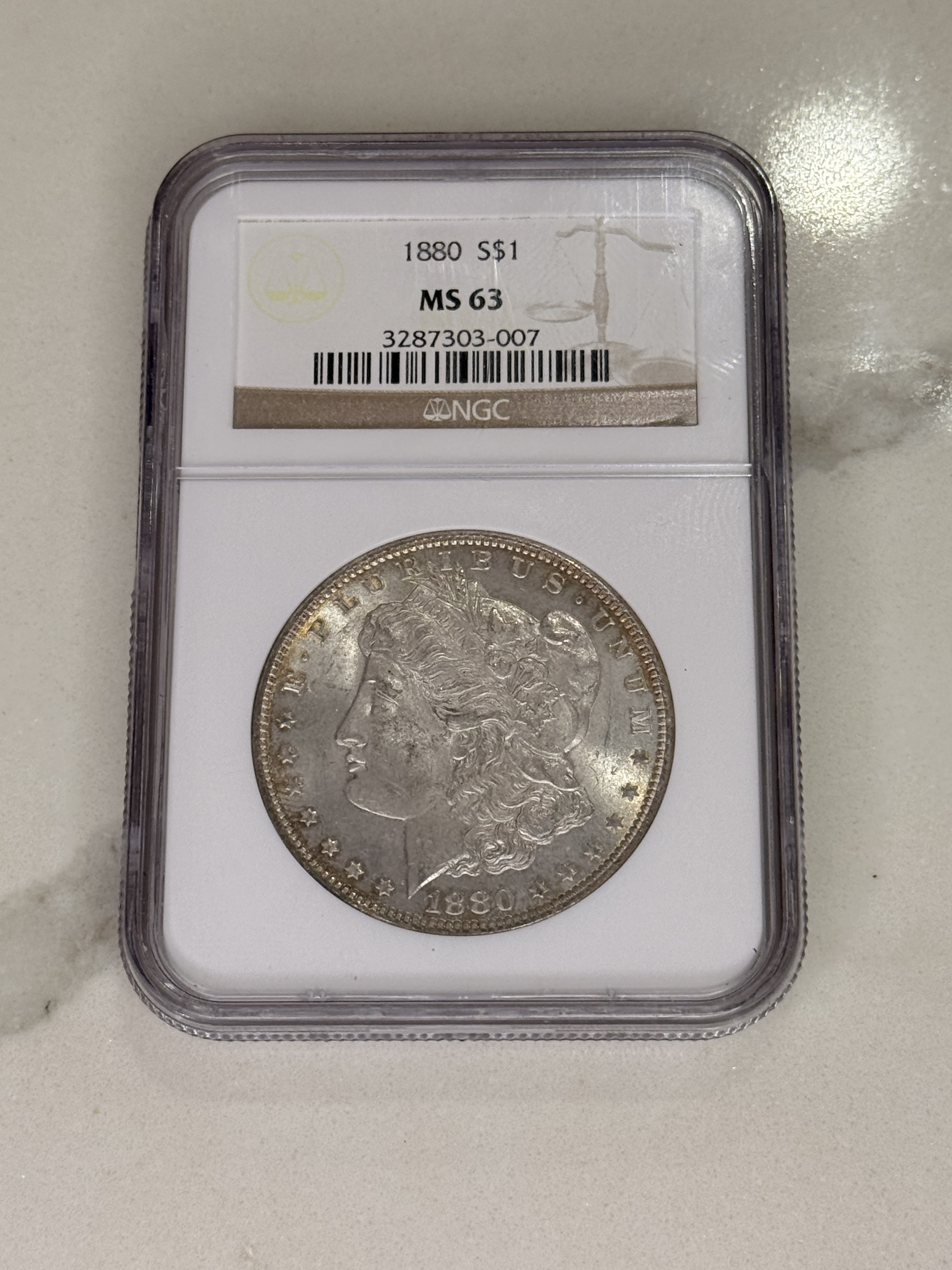 Actual coin and holder — front