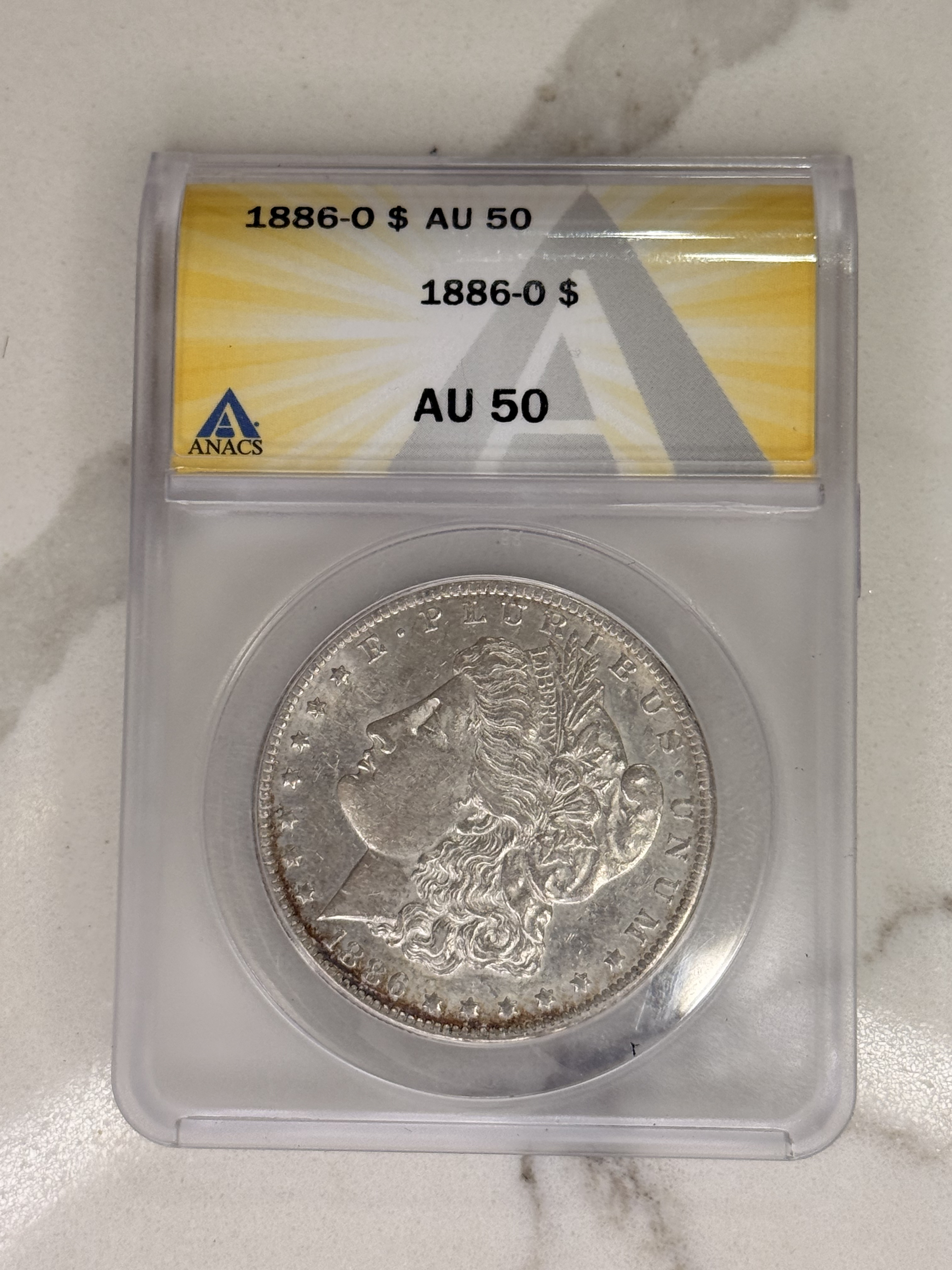 Actual coin and holder — front
