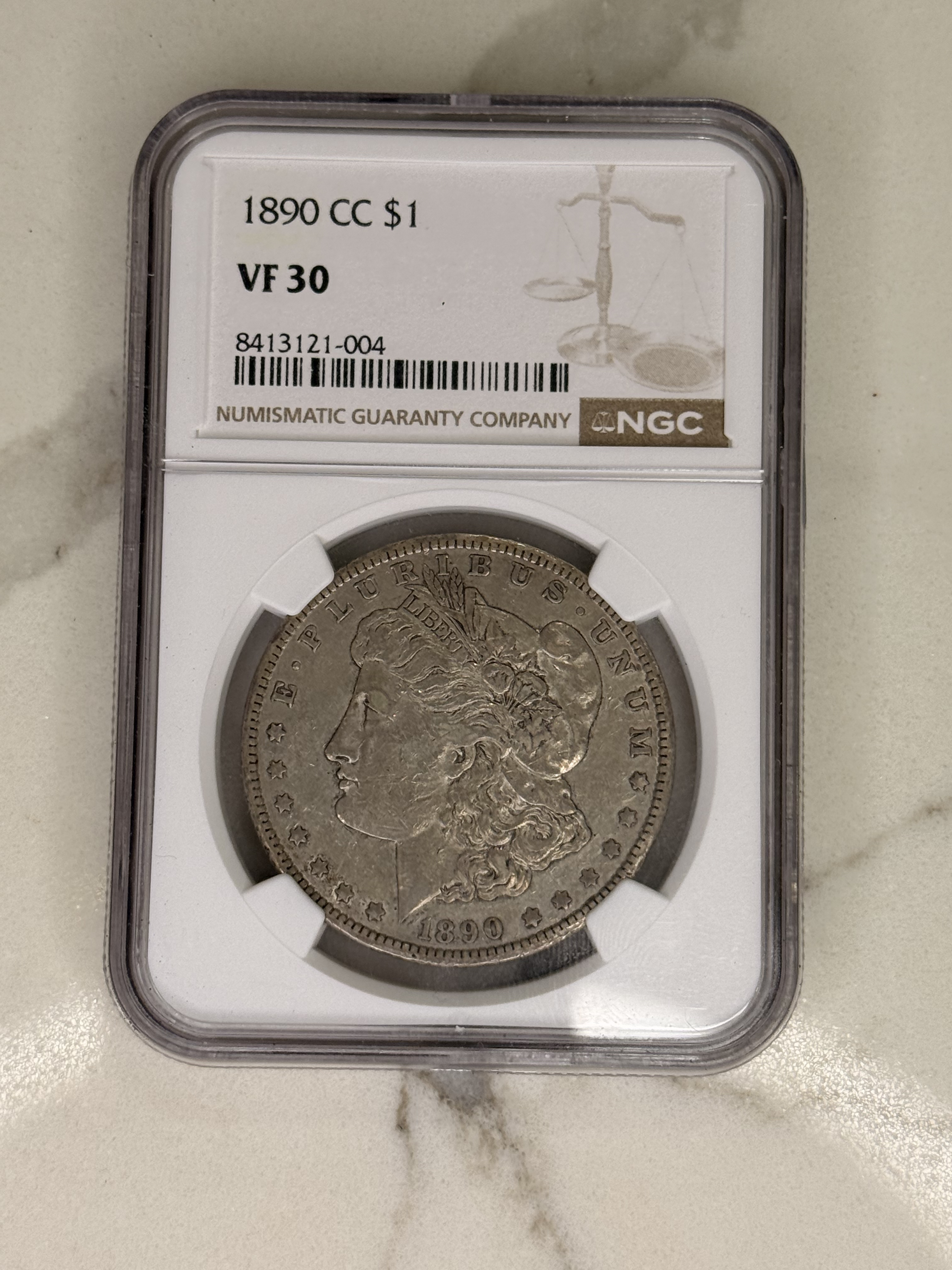 Actual coin and holder — front