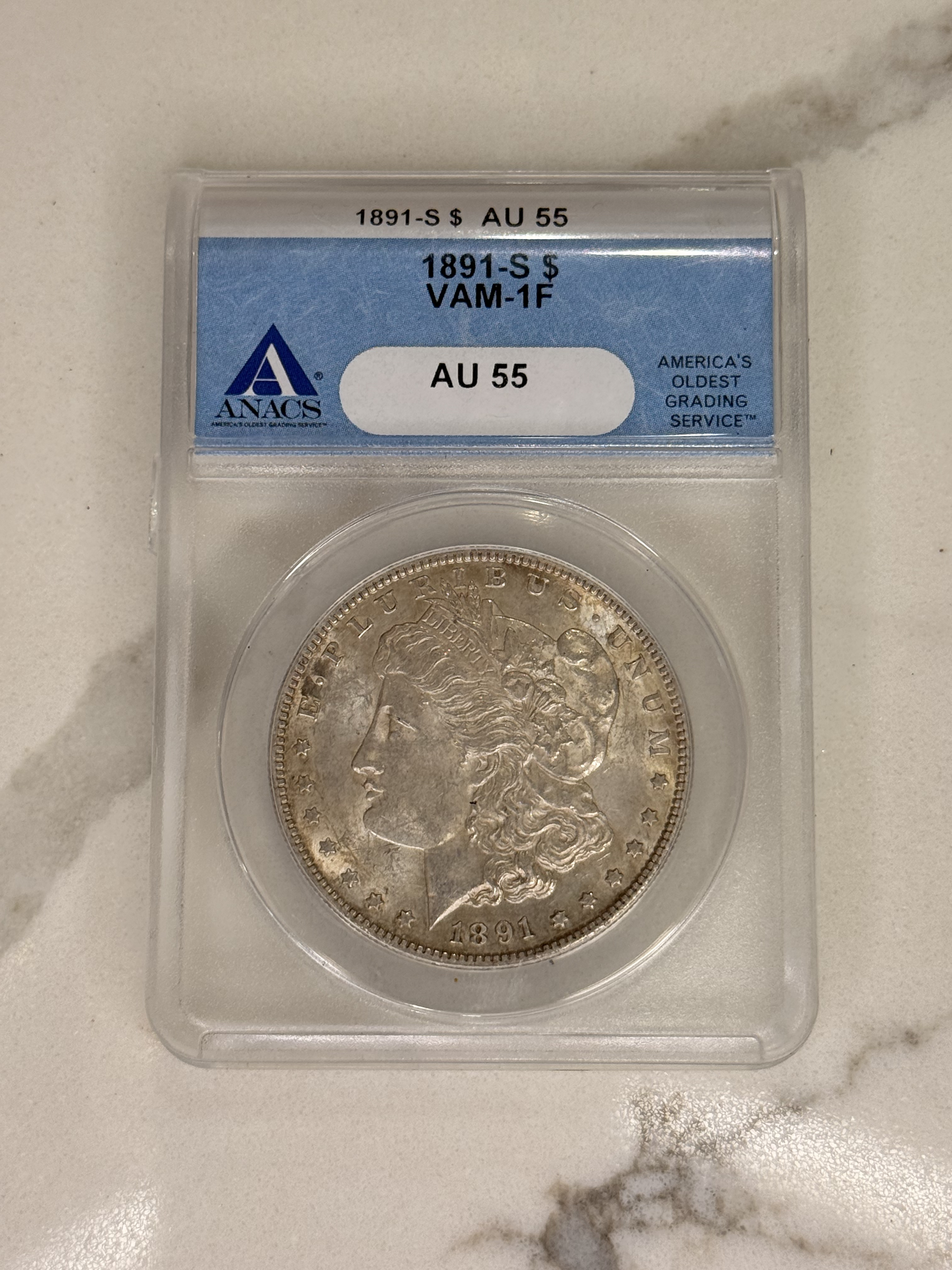 Actual coin and holder — front